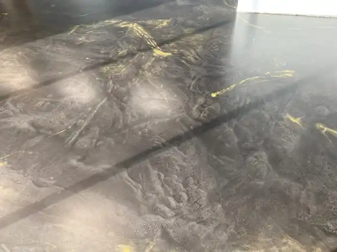 Close view of black metallic epoxy with gold veining