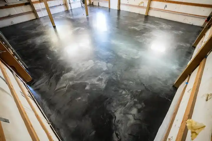 Black metallic epoxy floor inside a pole barn