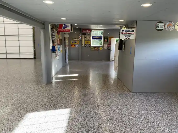 Finished glossy flake epoxy floor in a shop with vintage signs on the walls