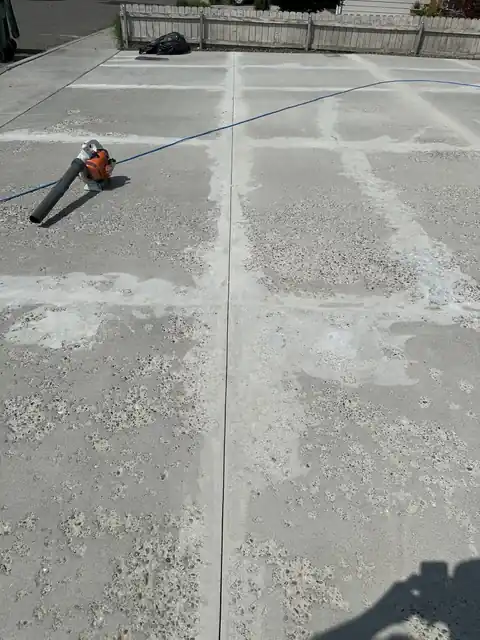 Driveway slab with patched pits and joints, cleaned and ready for an overlay