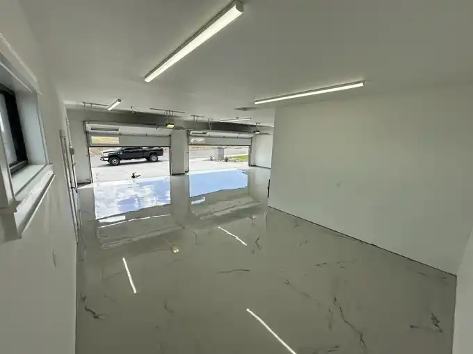 White marble-look metallic epoxy floor in a garage